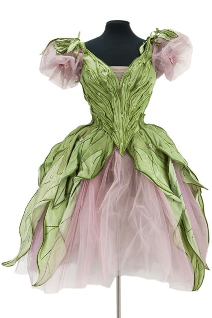 Hideous fairy princess costume with green fabric and pink tulle.