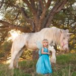 Toddler wears butterfly fairy princess costume to hang out with a unicorn