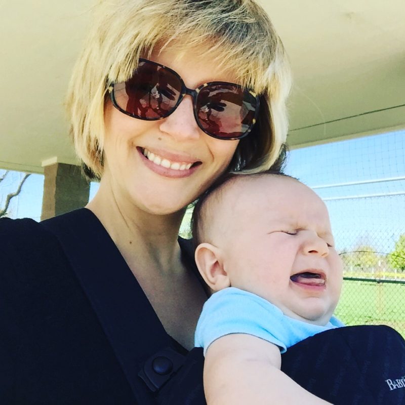 Here is a picture of a baby crying while mama takes a selfie. Good times. It's the About Me photo for the blog Two in Tow and On The Go in Paso Robles, California.