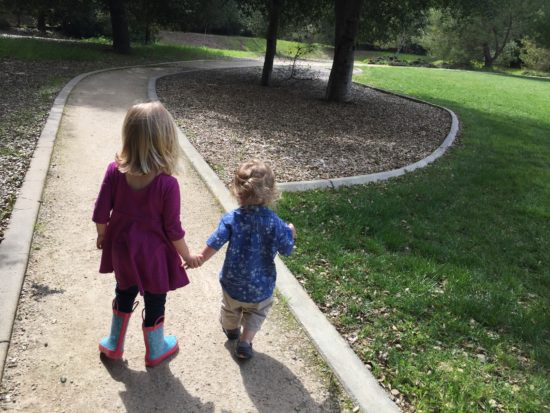 Two kids walk a dirt path at Apple Valley Park in Atascadero California