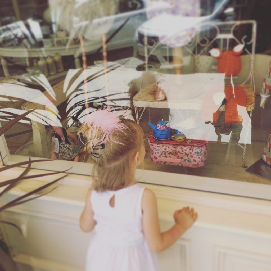Little girl Window shopping at Bijou in Downtown Paso Robles California