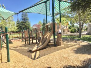 Sherwood Park playground with kid climbing slide tower