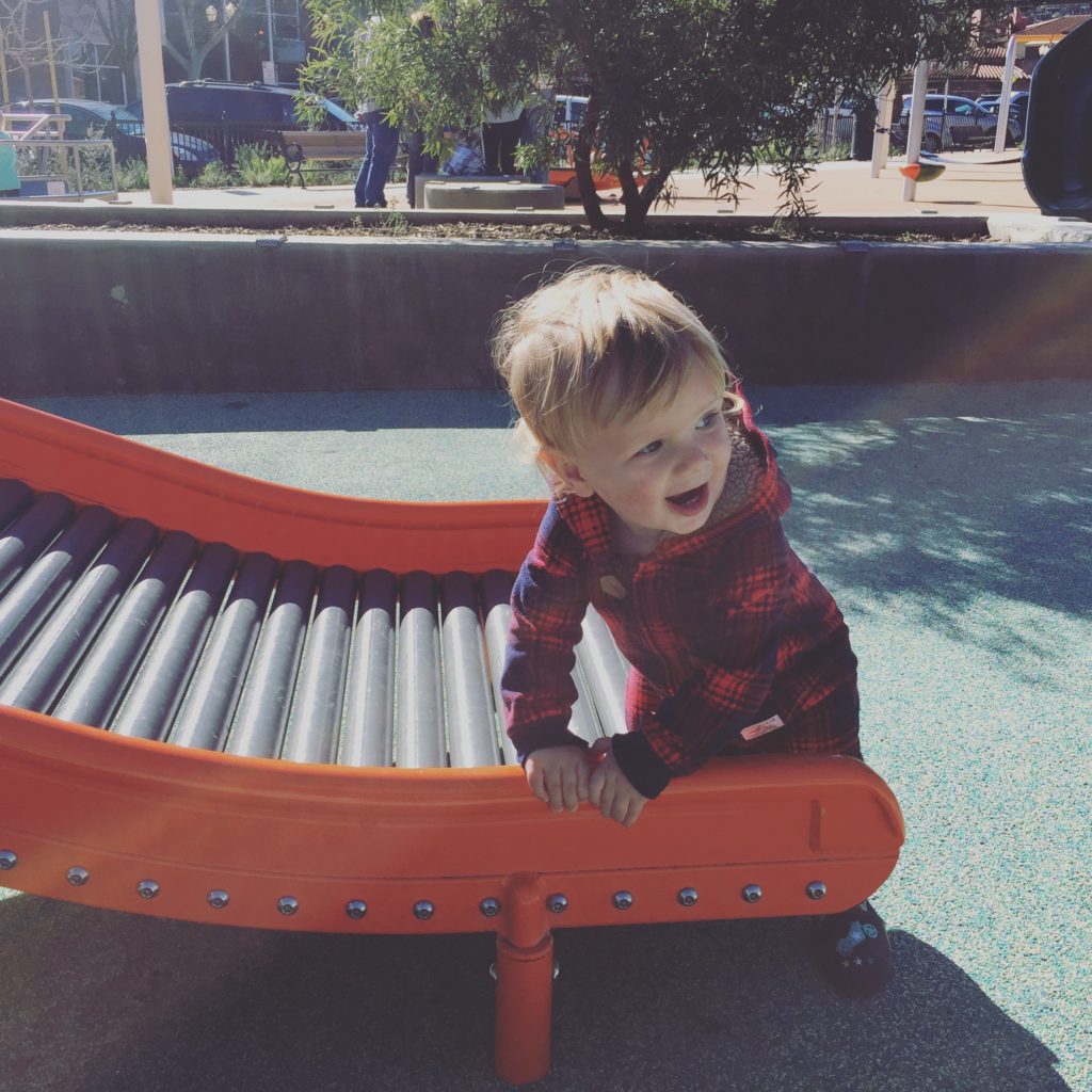 Baby on the roller slide at Paso Robles Downtown City Park playground