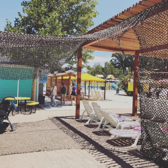 Shaded seating area by lockers at The Ravine Waterpark Paso Robles