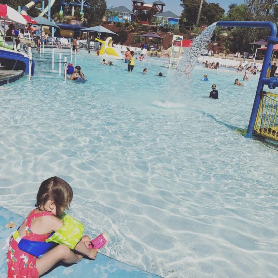 little girl in front of Tadpool at waterpark