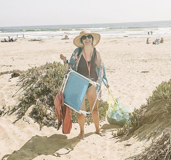 Mom at the beach hauling all her kids toys