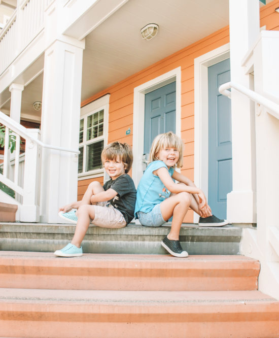 Two kids pose on hotel steps