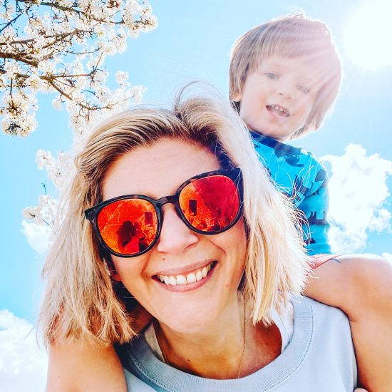 Mom and son outside with blue sky and trees