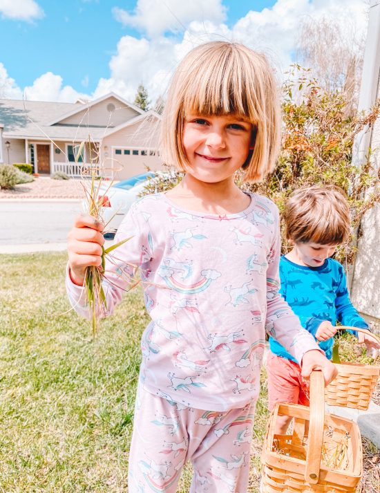 Little girl picking grass