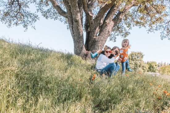 mom, son and daughter under an oak tree