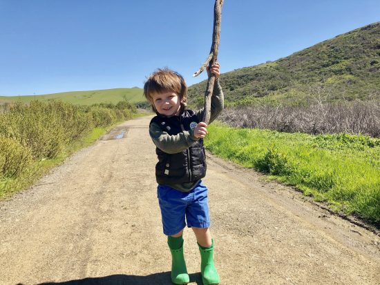 kid with giant hiking stick