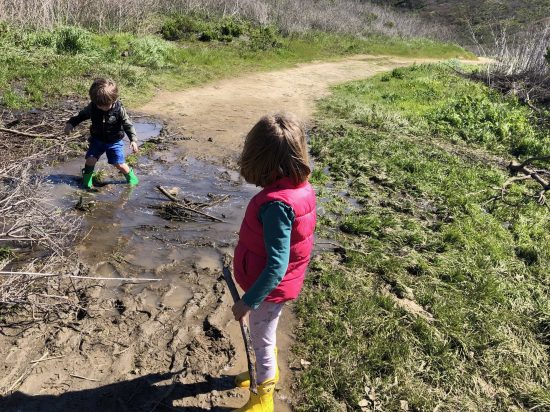 Kids walking in mud on hike