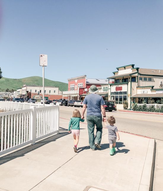 Dad and kids walking in a downtown setting