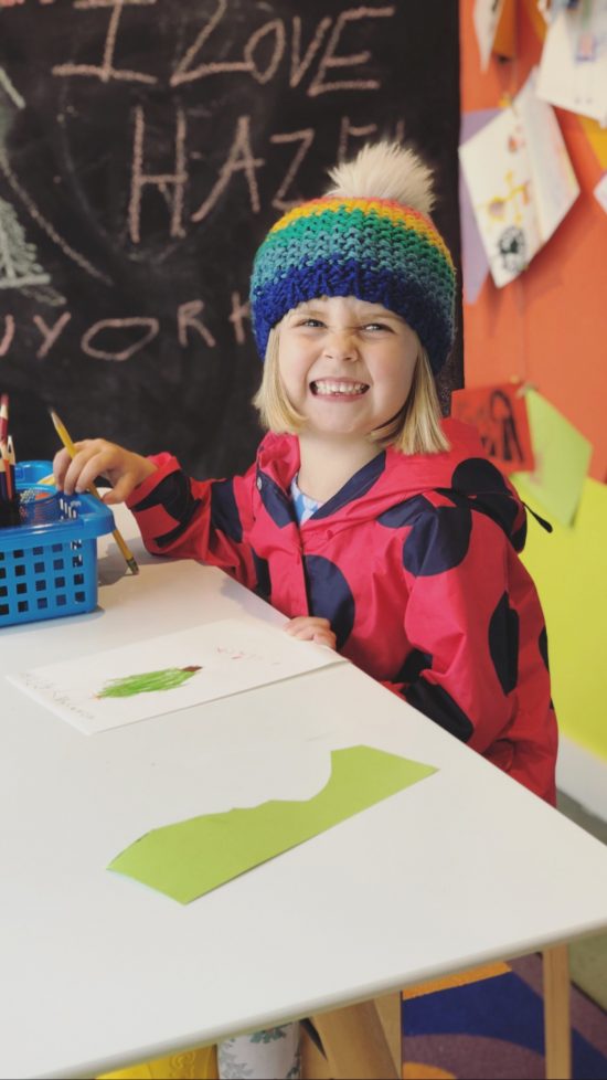 art desk with child smiling