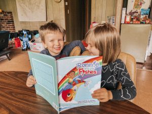 KIDS WITH BOOK SMILING