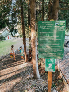 trail sign with kids in the foreground