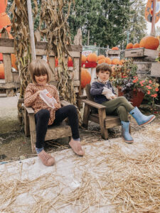 Little boy and girl eating popcorn at the pumpkin patch