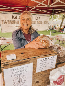 smiling woman with loaf of bread