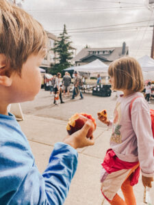 two kids with giant peaches in their hands