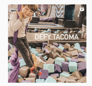 boy in foam pit with grey, purple and blue blocks