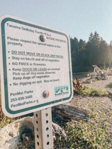 sign with text, trees in foreground