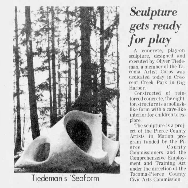 black and white newspaper clip with photo of a large rock with holes as public art.