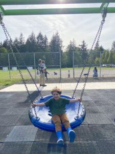 one child on blue disk swing