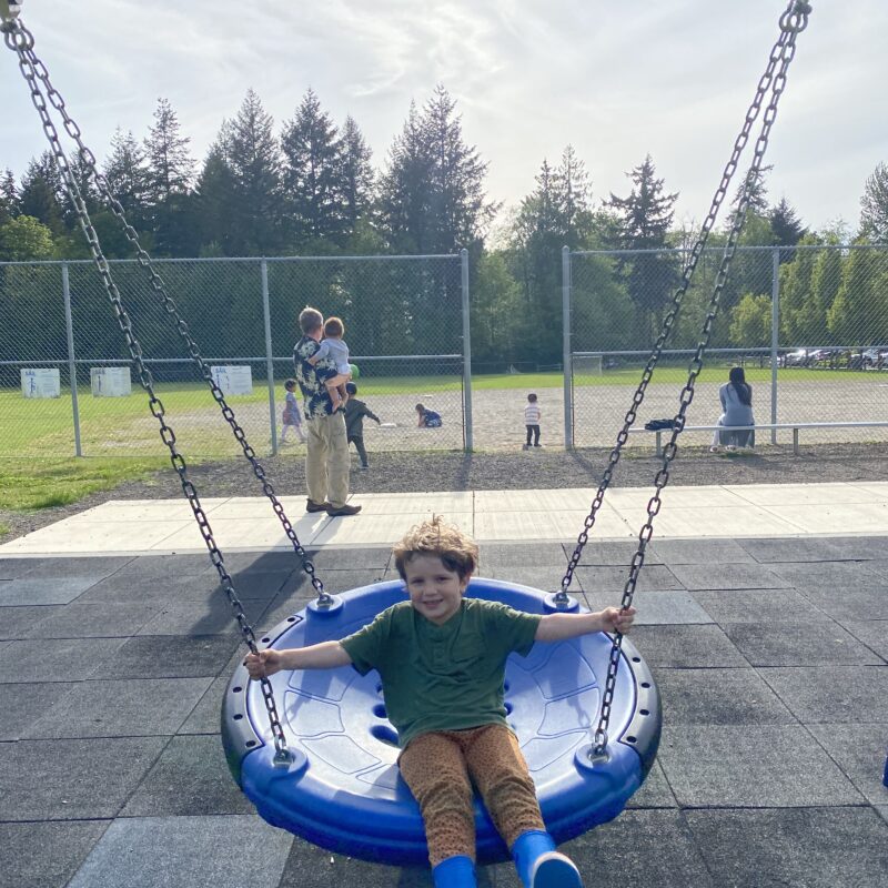 one child on blue disk swing