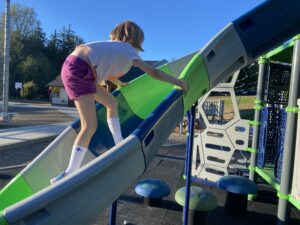 child climbing up slide