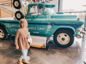 little girl next to teal vintage truck