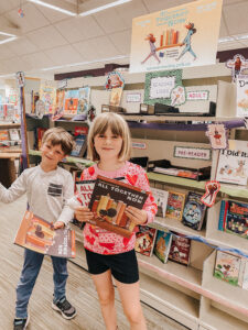 Kids in front of bookstacks